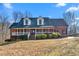 Inviting brick home with a full front porch and dormer windows providing extra light at 4639 Reid Rd, Elon, NC 27244