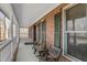 Inviting front porch with brick accents, seating and ample natural light at 4639 Reid Rd, Elon, NC 27244