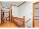 Hallway featuring hardwood floors, wooden trim, and stair access at 4639 Reid Rd, Elon, NC 27244
