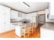 Bright kitchen featuring a center island with a gas cooktop and seating, and white cabinetry at 4639 Reid Rd, Elon, NC 27244