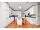 Bright kitchen with white cabinets, a center island, and modern appliances for culinary enthusiasts at 4639 Reid Rd, Elon, NC 27244