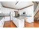 Well-lit kitchen with a functional island with seating, complemented by stainless steel appliances and white cabinetry at 4639 Reid Rd, Elon, NC 27244