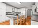 Spacious kitchen featuring white cabinets, a central island with seating, and stainless steel appliances at 4639 Reid Rd, Elon, NC 27244