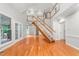 Spacious living area featuring hardwood floors, a staircase, and French doors leading to the exterior at 4639 Reid Rd, Elon, NC 27244