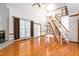 Open living room featuring vaulted ceilings, fireplace, and hardwood floors at 4639 Reid Rd, Elon, NC 27244