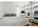 Bright bedroom features an open closet-shelf system, hardwood floors, and large window at 521 N Mangum St # 33, Durham, NC 27701
