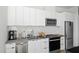Modern kitchen with stainless steel appliances, white cabinets, and updated countertops at 521 N Mangum St # 33, Durham, NC 27701