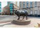 Bronze bull sculpture displayed in a vibrant downtown neighborhood with modern buildings at 521 N Mangum St # 33, Durham, NC 27701