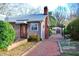 Lovely backyard featuring a brick walkway, garden, and shed, offering a serene outdoor space at 610 Westbrook Dr, Burlington, NC 27215