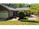 Backyard with garage and brick path leading to a peaceful garden and lots of grass at 610 Westbrook Dr, Burlington, NC 27215