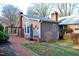 Outdoor space featuring a brick pathway, covered pergola, and landscaped garden, perfect for relaxation at 610 Westbrook Dr, Burlington, NC 27215