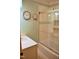 Bright bathroom featuring a shower and tub combination with a glass door at 610 Westbrook Dr, Burlington, NC 27215