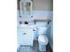 Bathroom with white cabinets, a toilet, a mirror, and white wainscotting at 610 Westbrook Dr, Burlington, NC 27215