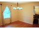Bright dining room with classic white paneling, hardwood floors, and an elegant chandelier at 610 Westbrook Dr, Burlington, NC 27215