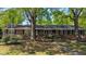 Charming brick home with a landscaped front yard, mature trees, and a welcoming entrance at 610 Westbrook Dr, Burlington, NC 27215