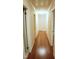 Hallway with hardwood flooring, access to multiple rooms and natural lighting at 610 Westbrook Dr, Burlington, NC 27215