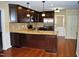 Modern kitchen with rich dark wood cabinets, granite countertops, stainless steel appliances, and hardwood floors at 610 Westbrook Dr, Burlington, NC 27215