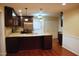 Open-concept kitchen with stainless steel appliances, wooden cabinets, and an island at 610 Westbrook Dr, Burlington, NC 27215