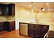 Kitchen with granite countertops, wooden cabinets, stainless steel appliances, and hardwood floors at 610 Westbrook Dr, Burlington, NC 27215