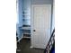 Basement storage area with shelving, countertop, and a closed door at 610 Westbrook Dr, Burlington, NC 27215