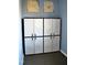 Two sets of matching white storage cabinets with black handles in the basement at 610 Westbrook Dr, Burlington, NC 27215