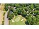Scenic aerial view of a well-maintained golf course surrounded by trees and residential homes at 7621 Wingfoot Dr, Raleigh, NC 27615