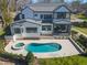 Aerial view showcasing a luxury backyard with a pool, spa, patio, and manicured landscaping at 7621 Wingfoot Dr, Raleigh, NC 27615