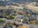 Aerial view of a neighborhood featuring a golf course and pond at 7621 Wingfoot Dr, Raleigh, NC 27615