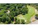 An aerial view of the neighborhood with a golf course surrounded by lush trees and well-maintained greens at 7621 Wingfoot Dr, Raleigh, NC 27615