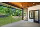 Relaxing screened porch with a ceiling fan and peaceful views of the wooded backyard at 7621 Wingfoot Dr, Raleigh, NC 27615