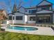 Stunning backyard featuring a swimming pool, spa, and outdoor living space for entertaining at 7621 Wingfoot Dr, Raleigh, NC 27615