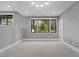 Spacious room with large windows offering natural light and a view of the surrounding trees at 7621 Wingfoot Dr, Raleigh, NC 27615