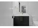 Elegant powder room with a marble countertop, matte black cabinet, and designer gold fixtures at 7621 Wingfoot Dr, Raleigh, NC 27615