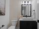 Modern bathroom featuring a sleek black vanity, white countertop, and decorative vase at 7621 Wingfoot Dr, Raleigh, NC 27615