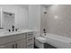 Bathroom featuring a vanity with drawers, toilet, and a tub with patterned tile at 7621 Wingfoot Dr, Raleigh, NC 27615