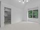 Serene bedroom with large windows, recessed lighting, and closet access at 7621 Wingfoot Dr, Raleigh, NC 27615