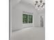 Bright, airy bedroom featuring high ceilings, large windows, and neutral carpet at 7621 Wingfoot Dr, Raleigh, NC 27615