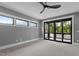 Bedroom featuring carpet, multiple windows, and a glass sliding door for natural light at 7621 Wingfoot Dr, Raleigh, NC 27615