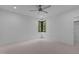 Bright bedroom with a ceiling fan, carpet, and corner windows overlooking the trees at 7621 Wingfoot Dr, Raleigh, NC 27615