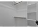 White walk-in closet with shelving and hanging rods for organization and storage at 7621 Wingfoot Dr, Raleigh, NC 27615
