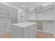 Custom walk-in closet features an island with drawers and adjustable shelving, maximizing space at 7621 Wingfoot Dr, Raleigh, NC 27615