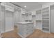 Spacious walk-in closet boasts custom shelving, drawers, and center island for optimal storage at 7621 Wingfoot Dr, Raleigh, NC 27615