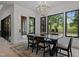 Bright dining area with backyard views, modern chandelier and beautiful area rug at 7621 Wingfoot Dr, Raleigh, NC 27615