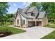 Beautiful two-story home with a two-car garage, manicured lawn, and stone and siding exterior at 7621 Wingfoot Dr, Raleigh, NC 27615