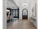 An open foyer features light hardwood flooring, a stylish chandelier, and an adjacent dining area at 7621 Wingfoot Dr, Raleigh, NC 27615