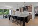 Modern kitchen features a large island with black stools and stylish pendant lighting at 7621 Wingfoot Dr, Raleigh, NC 27615