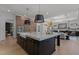 Luxury kitchen with a large island, breakfast bar, stylish pendant lighting, and high-end finishes at 7621 Wingfoot Dr, Raleigh, NC 27615