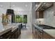 Bright kitchen with stainless steel appliances, light countertops, a farmhouse sink, and a view to the outdoors at 7621 Wingfoot Dr, Raleigh, NC 27615