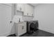 Modern laundry room features new front-load washer and dryer and a utility sink at 7621 Wingfoot Dr, Raleigh, NC 27615