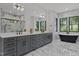 Elegant bathroom with dual vanities, soaking tub, and luxurious marble accents throughout at 7621 Wingfoot Dr, Raleigh, NC 27615